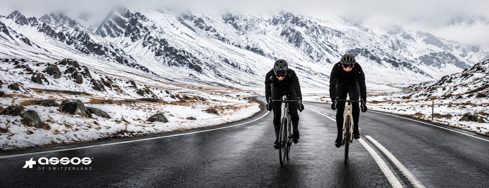Cyclists wearing ASSOS winter clothing on a snowy Alpine road