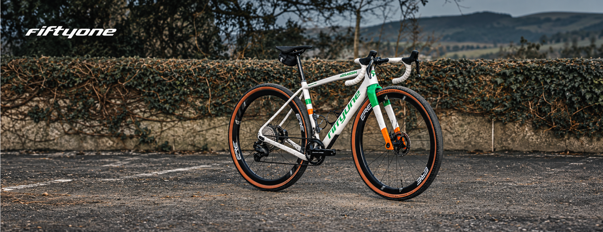 A Big Maggy&rsquo;s client&rsquo;s white FiftyOne Assassin gravel bike with green and orange details and ERE wheels